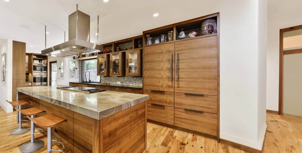 Wood-themed kitchen with eating area and curved bar chairs